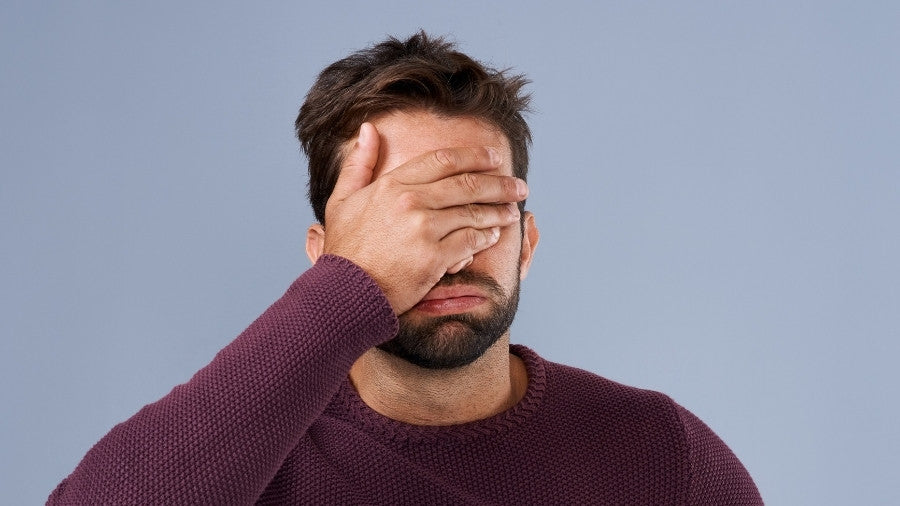 Man made a mistake and has his hand on his head