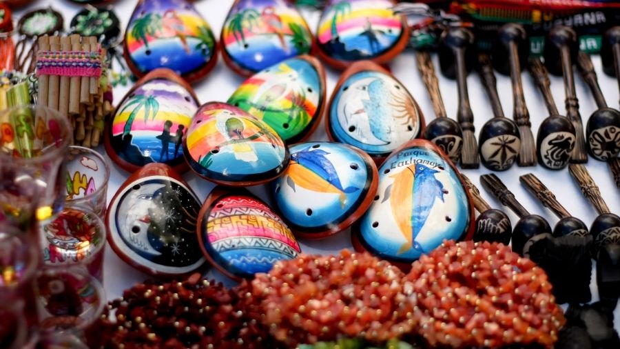 Ocarinas, pipes, and handcrafted necklaces from Venezuela displayed together.
