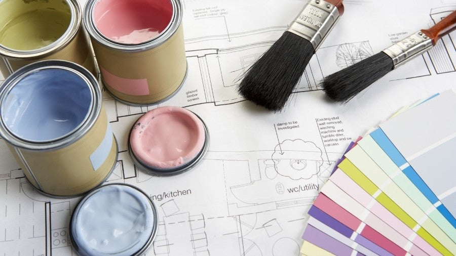 Paintbrush next to colour palettes