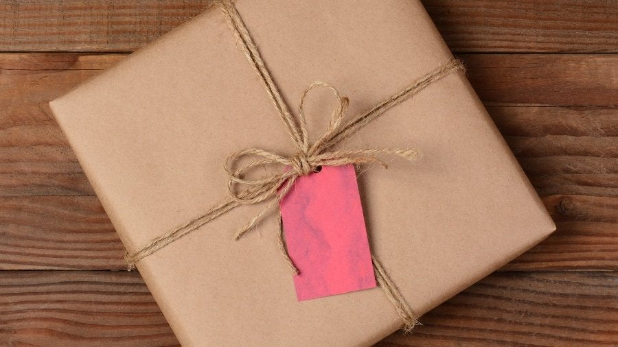 Packaged product wrapped in kraft paper with jute bow