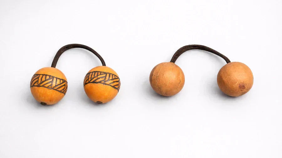 tribal wooden kashaka next to gourd African kashaka