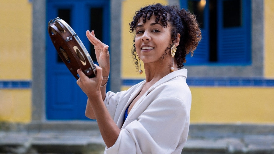Woman Playing the headed wooden tambourine outside
