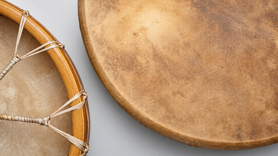 Shamanic drums of different size and a shamanic drum beater