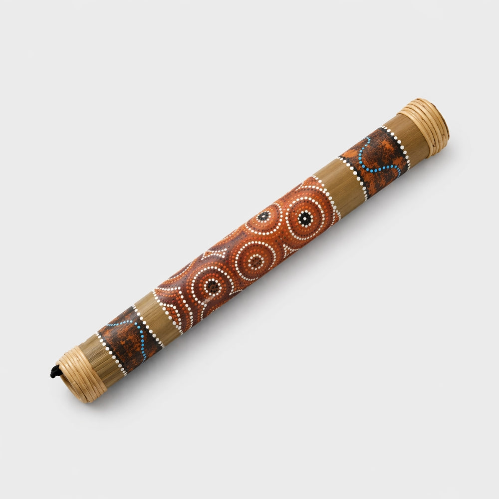 Large decorative 50cm bamboo rainstick with aboriginal painted art pattern on a light gray studio background