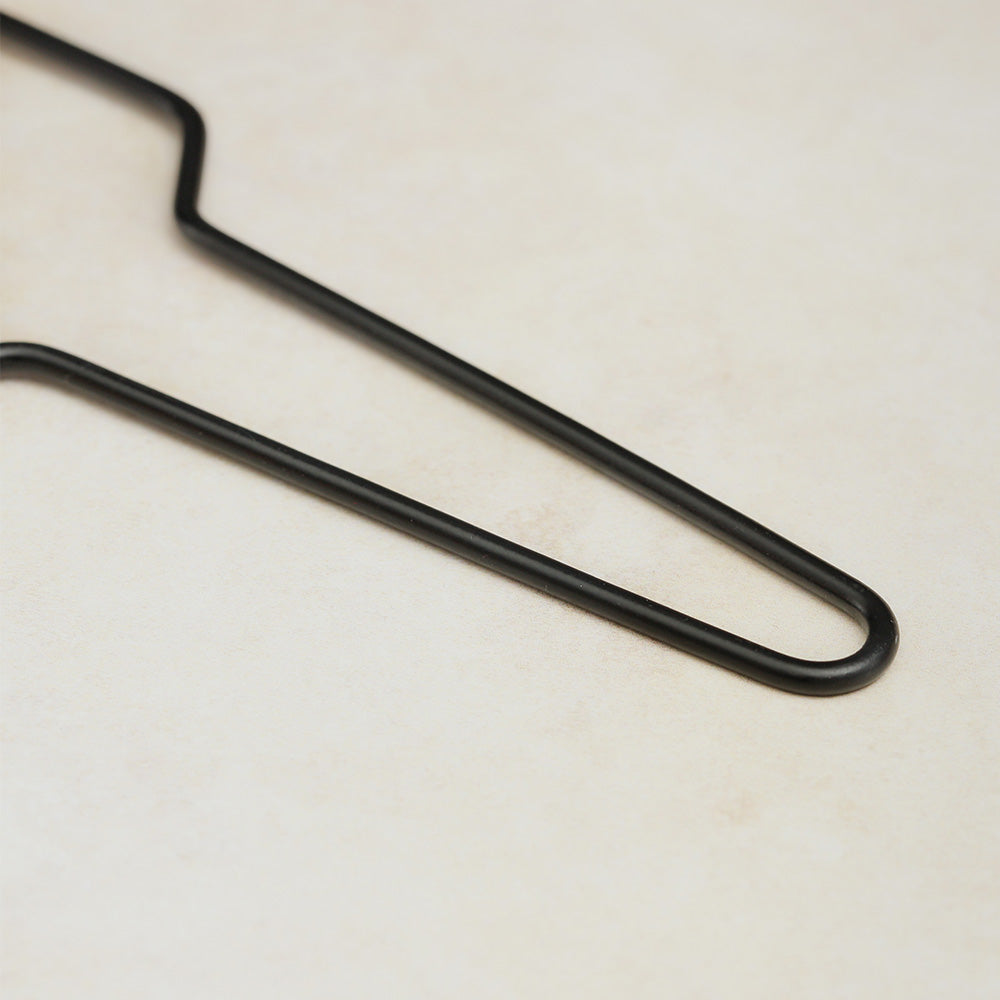 Close-up of the black metal flexatone handle, showing its shape and finish.