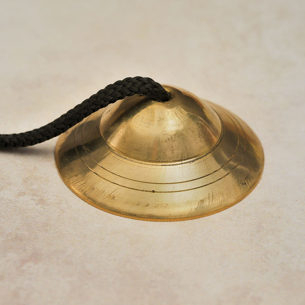 Close-up of the closed end of Brass Manjira Prayer Bells, showing the smooth finish.