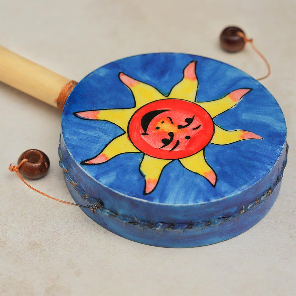 Close-up of the monkey drum head showcasing the blue design with an orange sun featuring a face.
