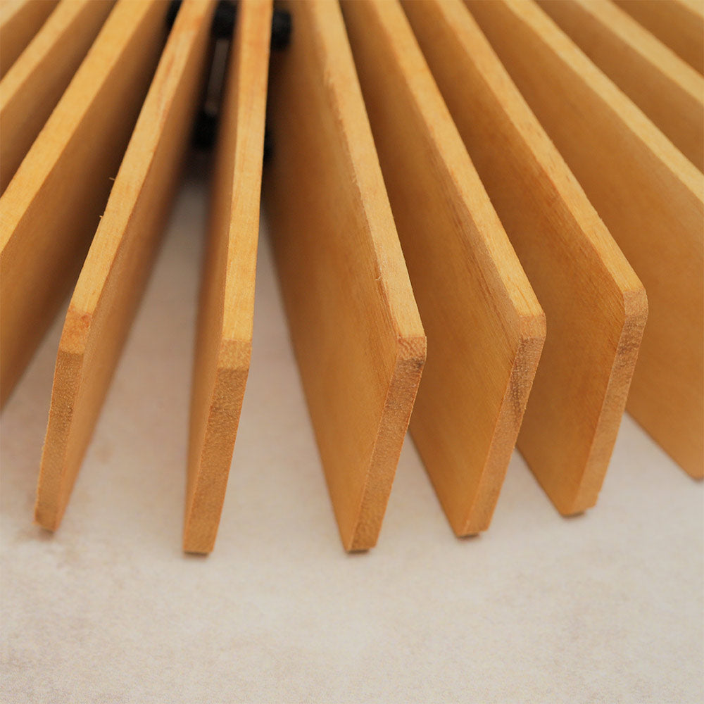 Close-up view of wooden kokoriko slats, highlighting their texture and how they clang together to create rhythmic sounds.