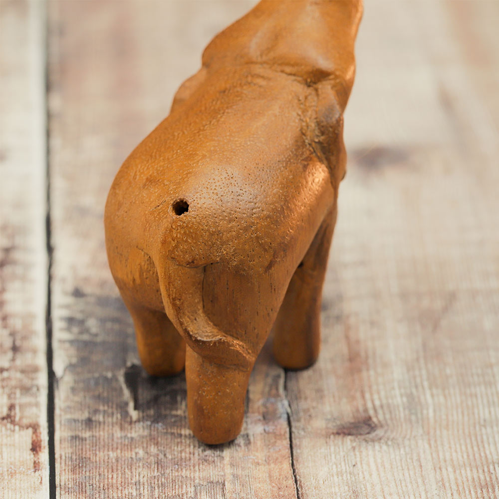 Close-up of the wooden Noisy Elephant Whistle, showing the back end where the whistle is blown.