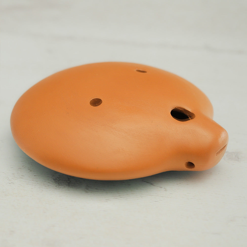 Bottom of the clay inca ocarina showing the holes