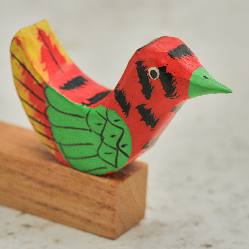 Close up of the hand painted wooden mesari bird with colourful detailing