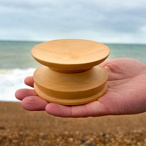 hand holding dewa singing bowl stand