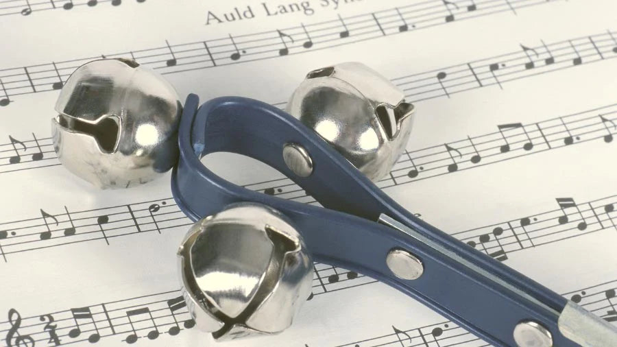 Small Metal Cowbells with Plastic Strap on Sheet Music