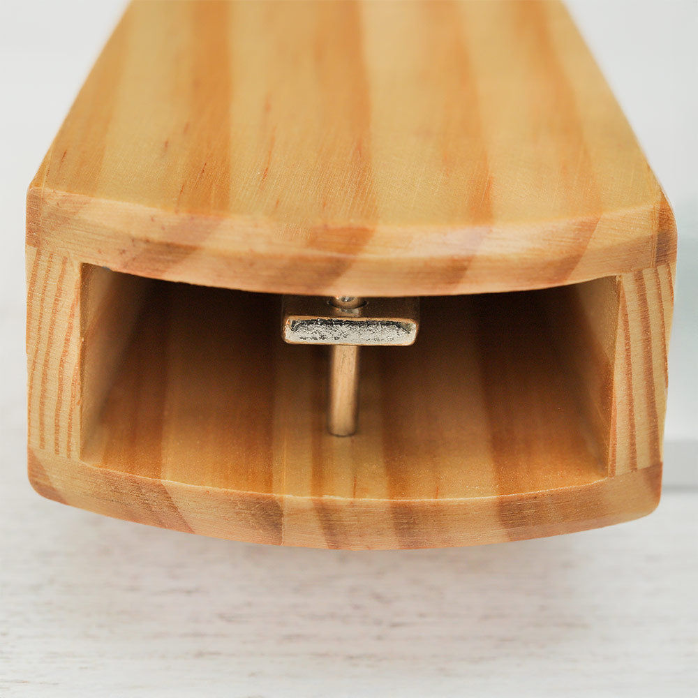 Extreme close-up of the wooden block mechanism on a Guan Vibraslap instrument, showing detailed wooden texture.