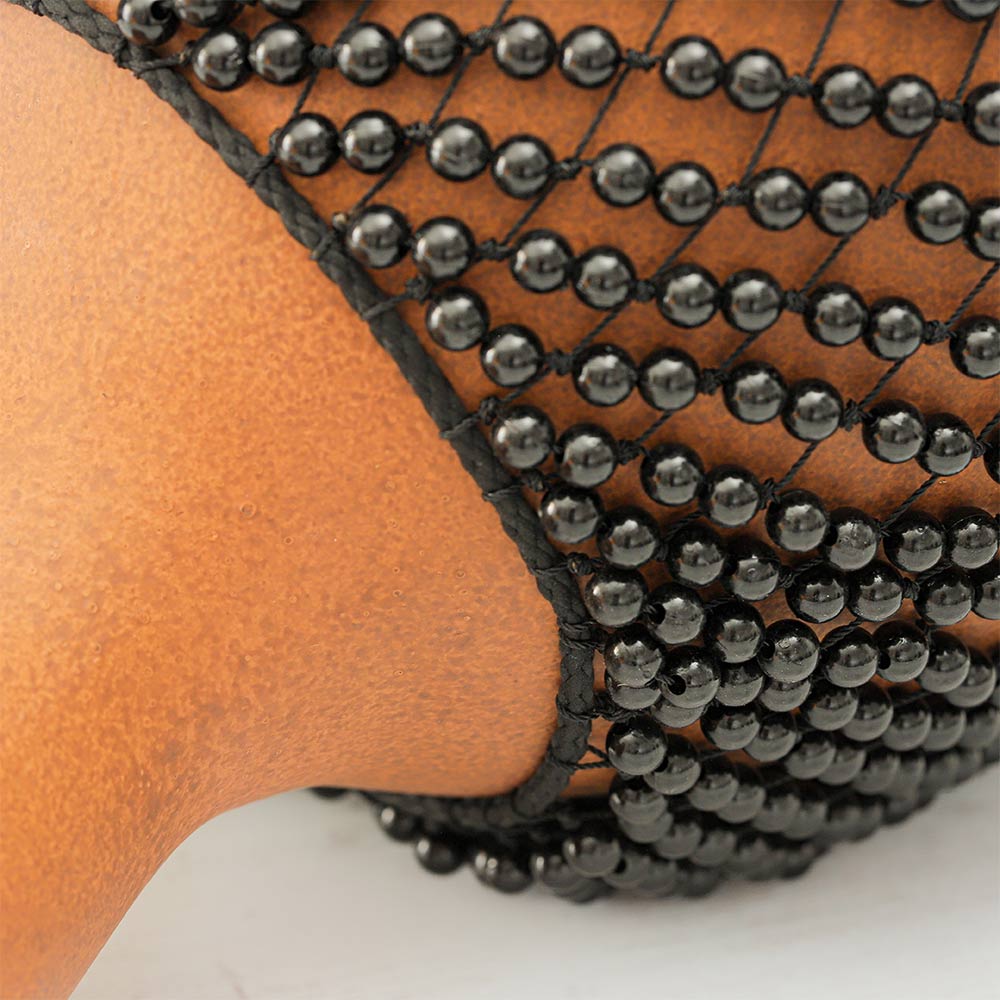 Close-up of the Fibreglass Shekere showing the textured handle and detailed beads.