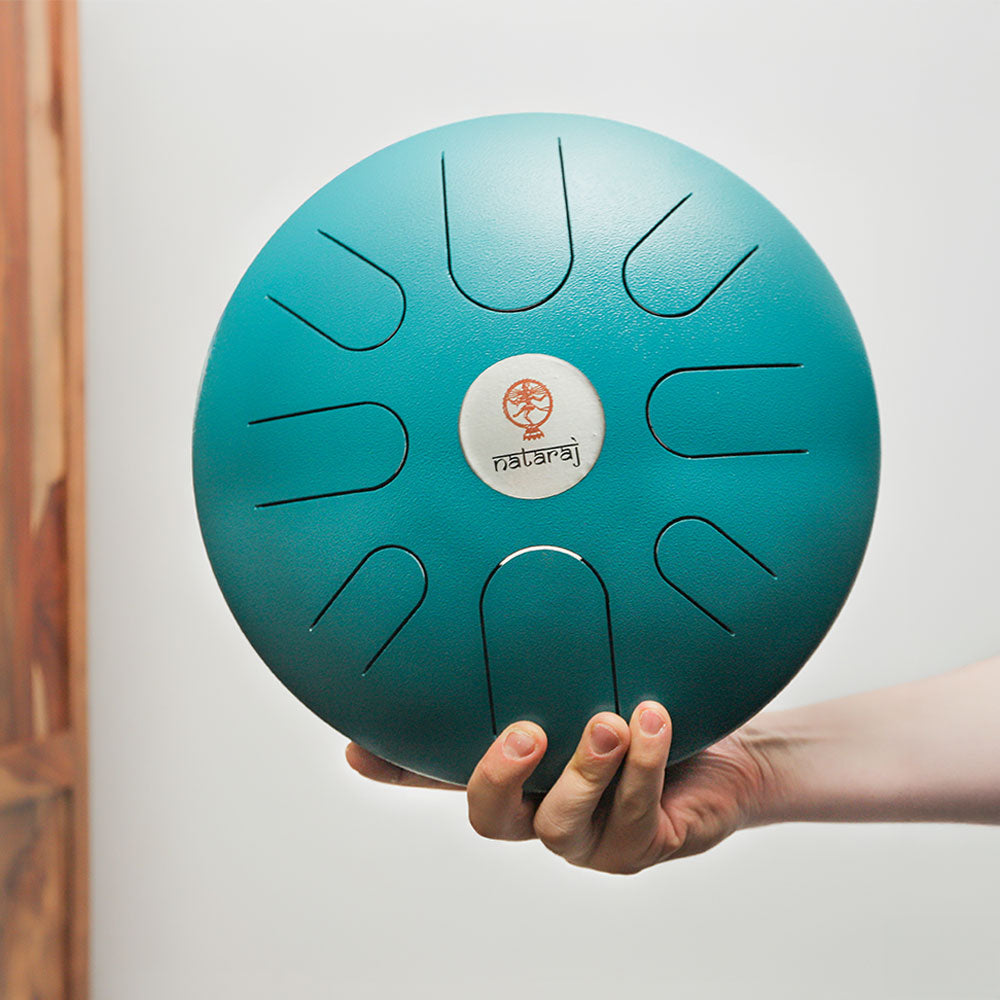 Indian Blue Nataraj tongue drum held in hand, demonstrating its size and design.