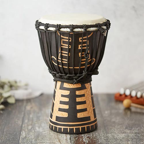 carved black and brown wooden djembe drum