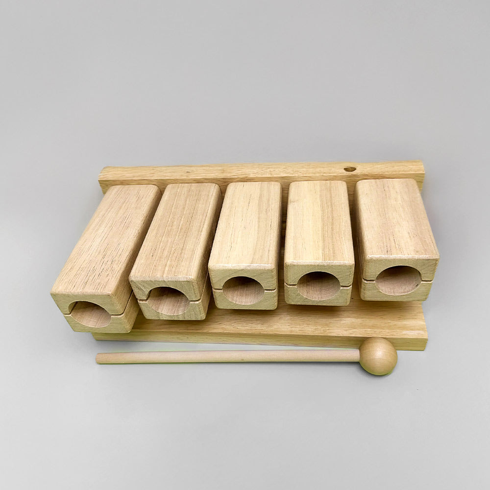 Front view of the Matsu Goonkai Tone Block, showcasing five notes made of solid wood with a beater.