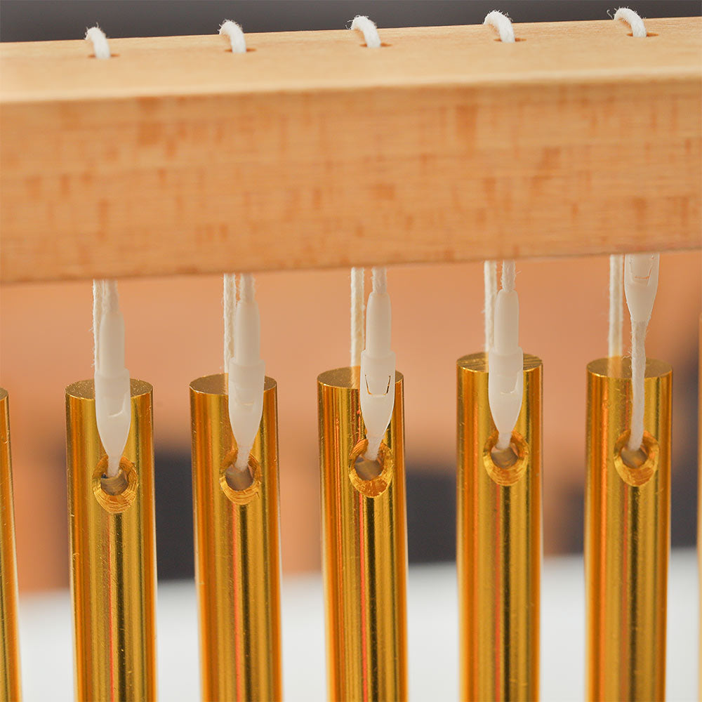 Close-up of Matsu metal chimes and the wooden frame stand showing construction and detail.