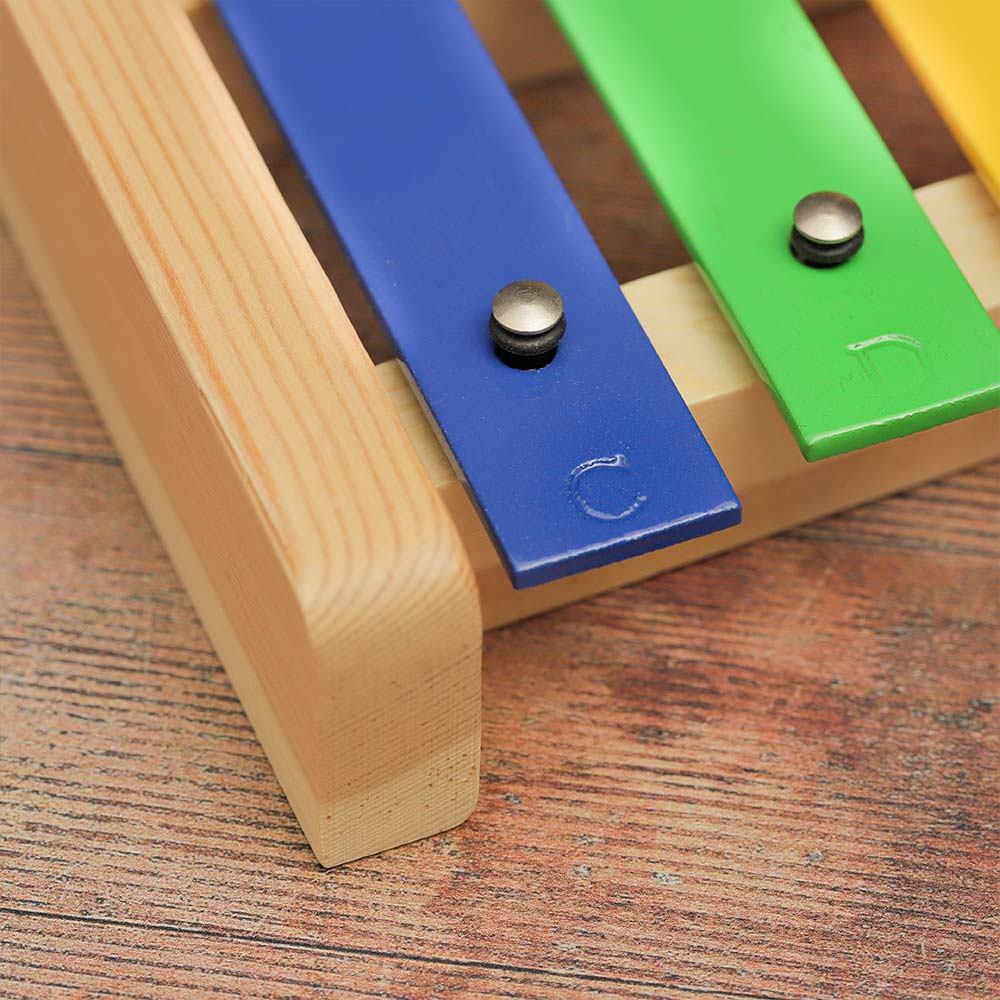 Close-up of the Niwa metallophone, highlighting the notes (C, D, etc.) on the metal bars.