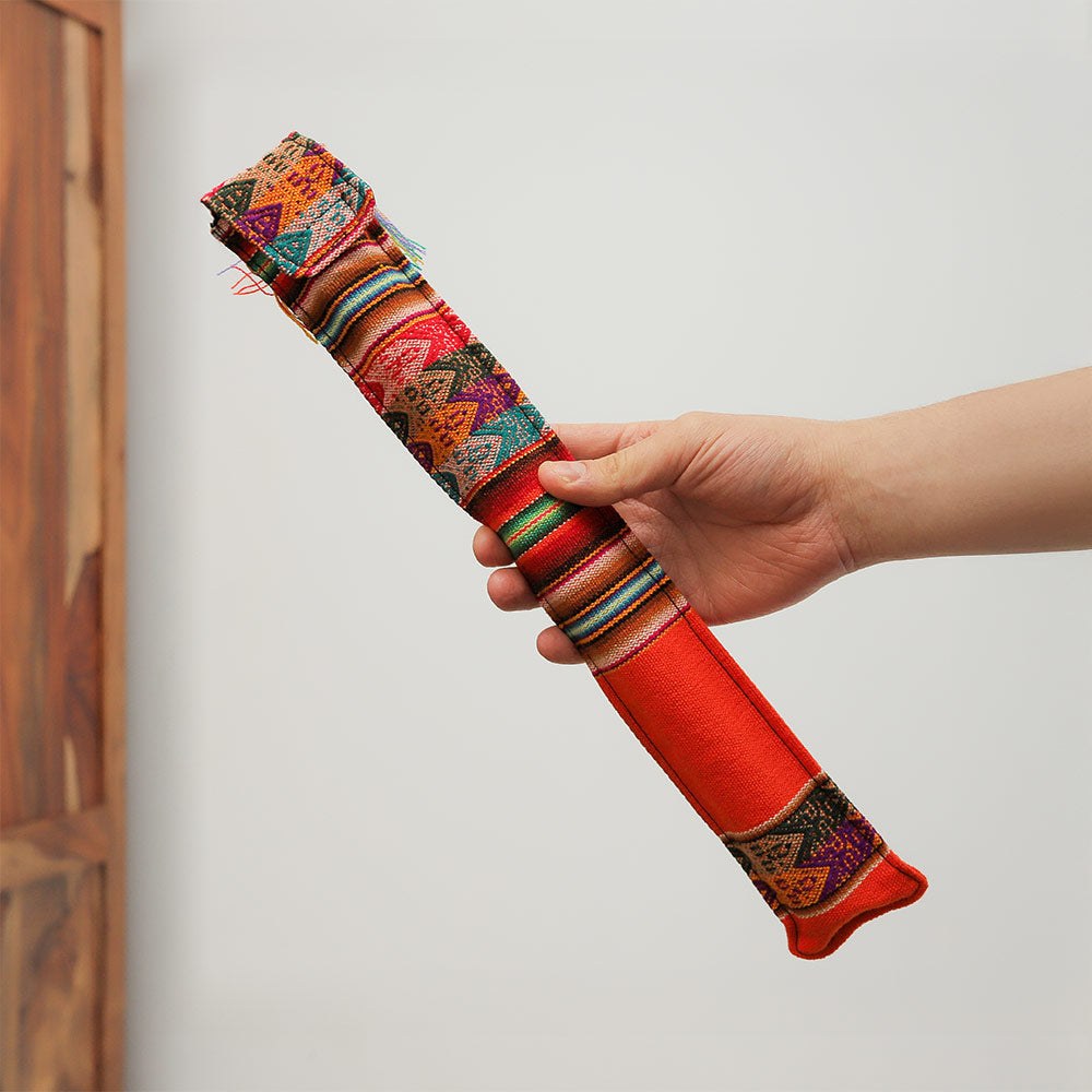 Quena Andean flute in a colourful fabric case, held in hand to show scale.