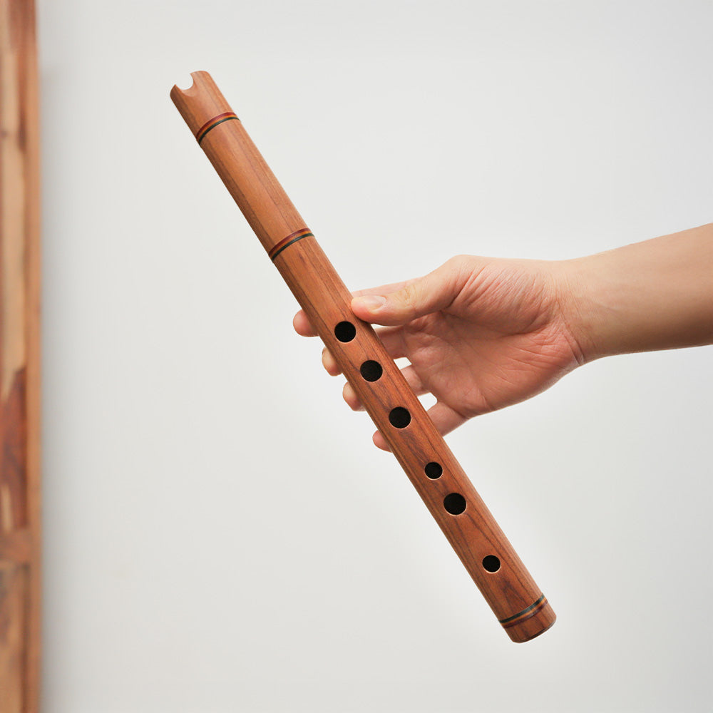 Quena Andean wooden flute, held in hand to show scale.