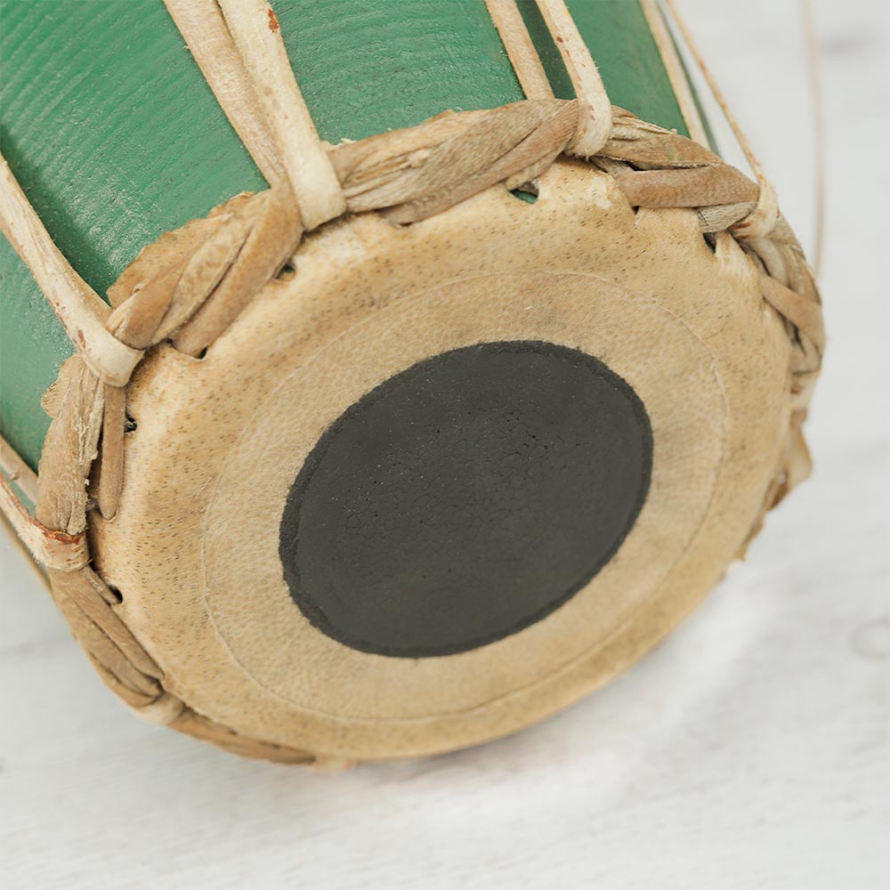 Close-up of the reverse side of the green Nepalese Madal drum head, showing the smaller syahi (tuning spot)