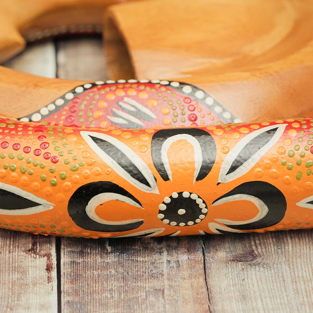 Close-up of the hand-painted design on the wood of the Spiral didgeridoo, showcasing intricate artwork.