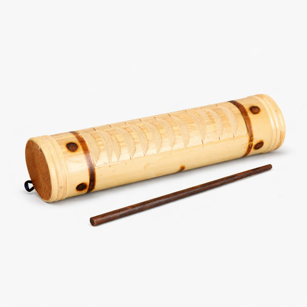 Solid aboriginal bamboo guiro shaker with stick scraper on plain background