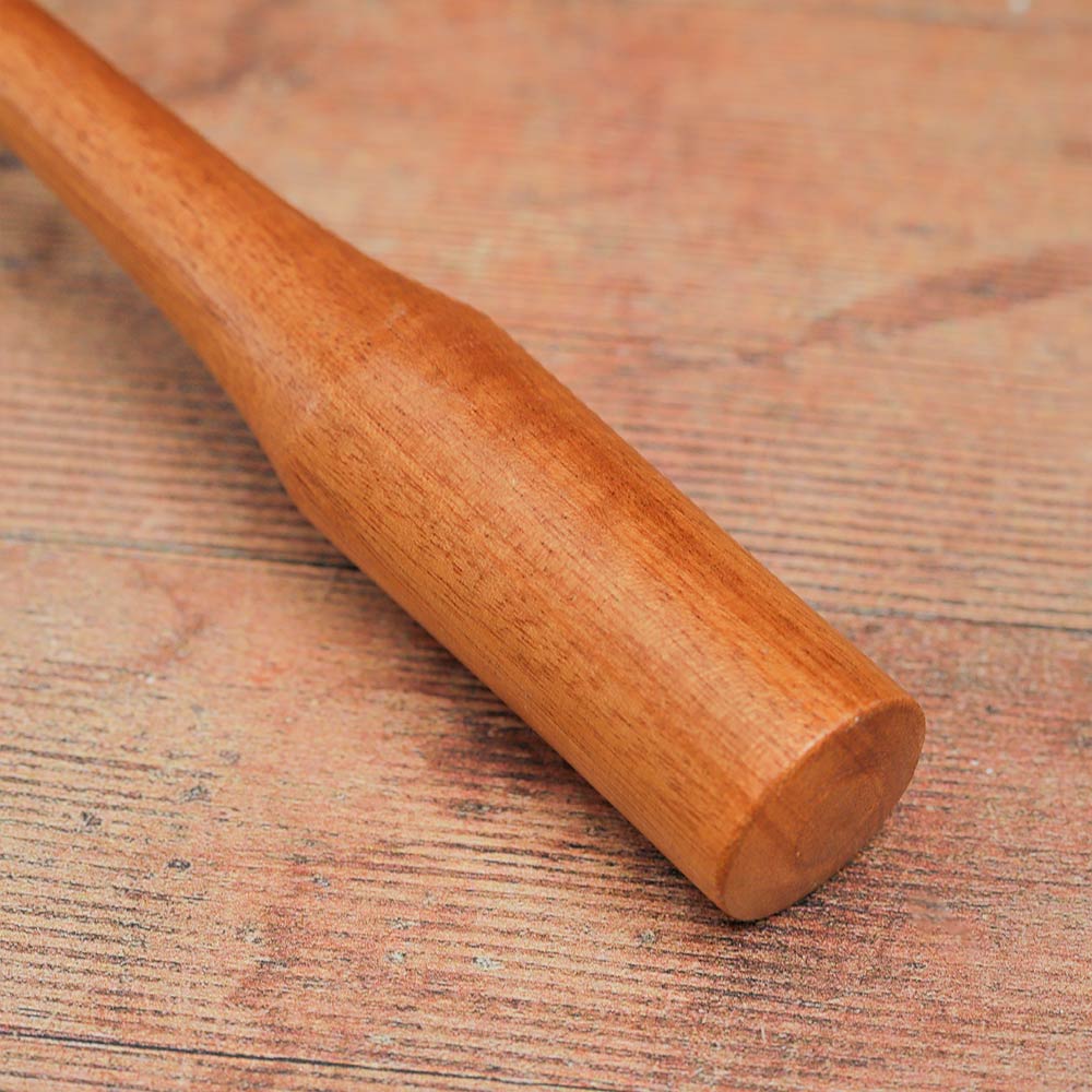 Close-up of the handle of the wooden monk bell, highlighting its smooth texture and design.