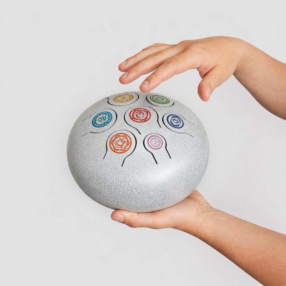 chakra white tongue drum in hand