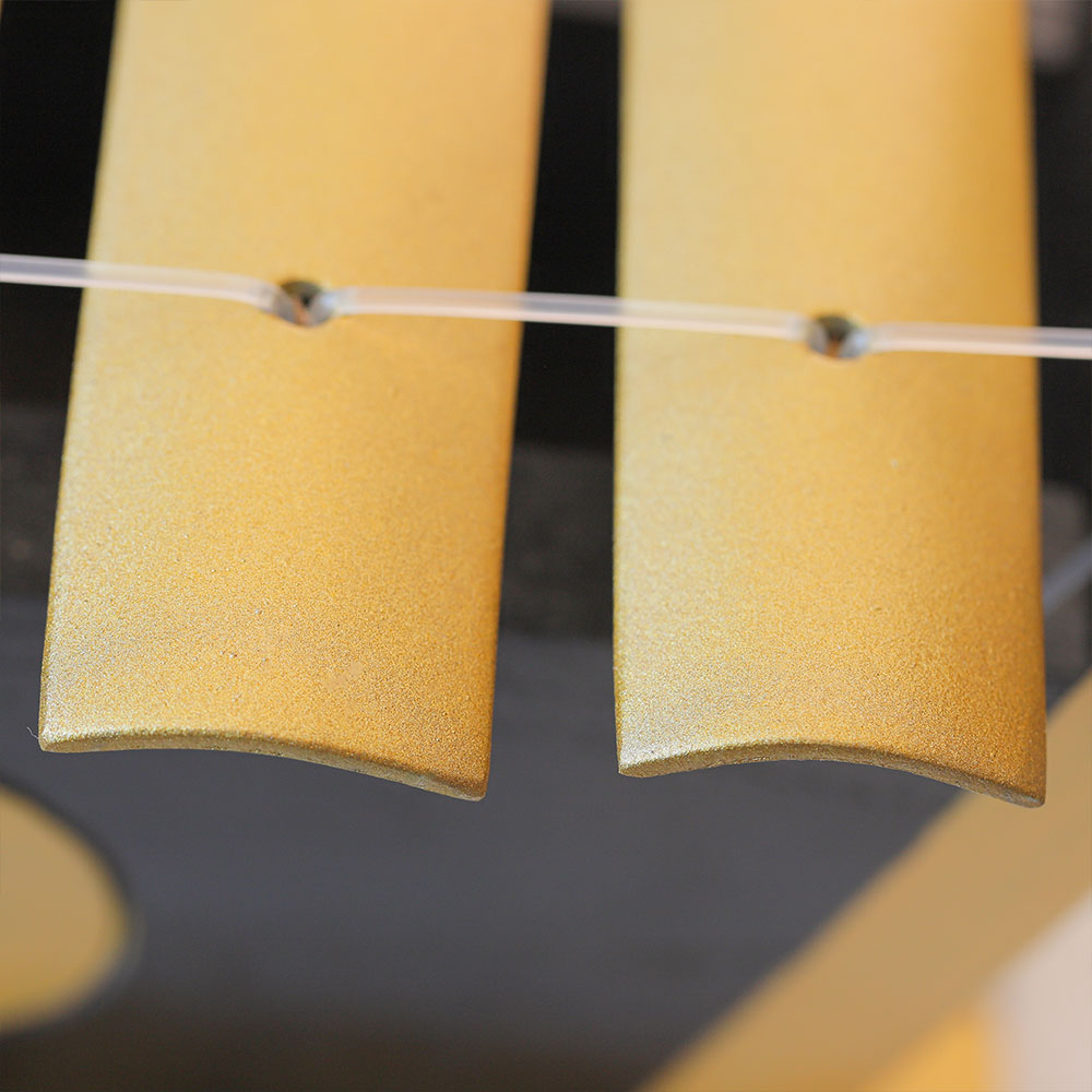 close up of golden gangsa gamelan keys