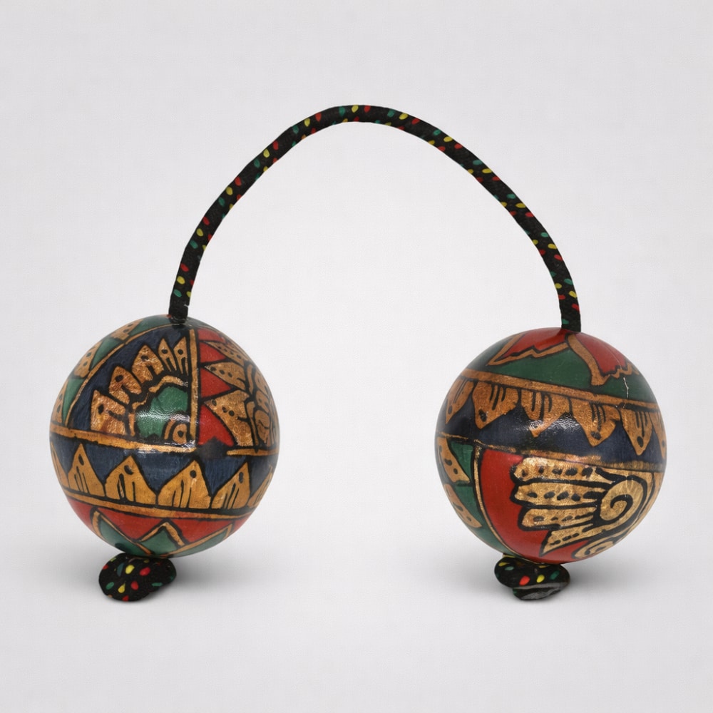 Geometric Design Cas Cas Kashaka shaker Instrument with rope on a white studio background