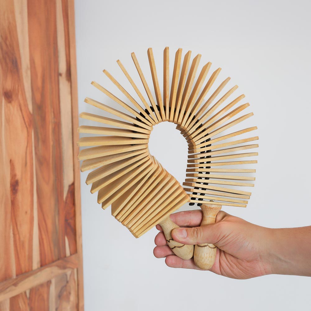 scale image of wooden kokoriko in hand