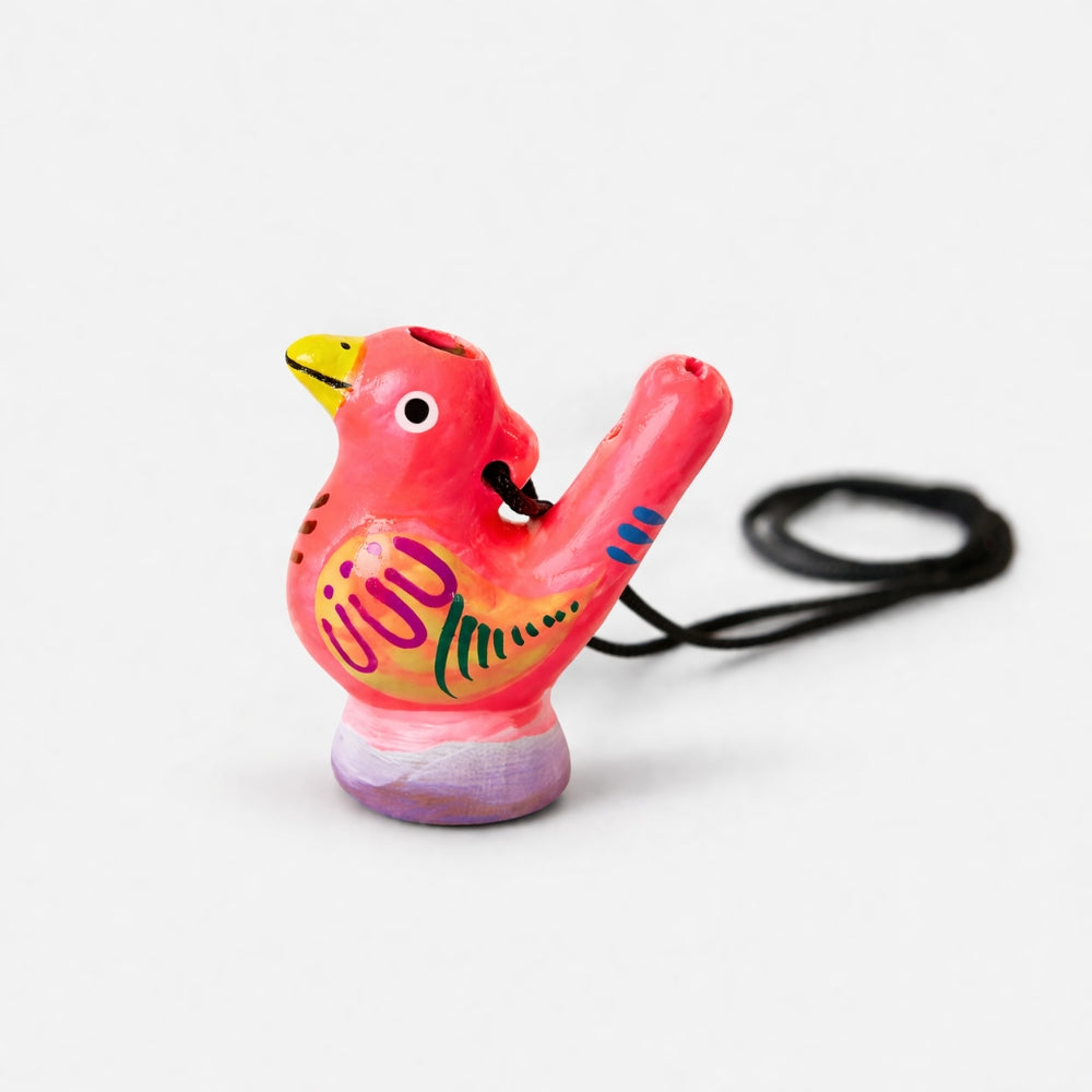 Pink bird-shaped whistle with a black cord on a white background
