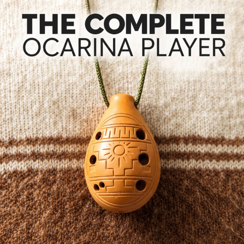 An ocarina pendant hanging from a green cord against a knitted beige and brown background, with large text at the top reading 'THE COMPLETE OCARINA PLAYER'