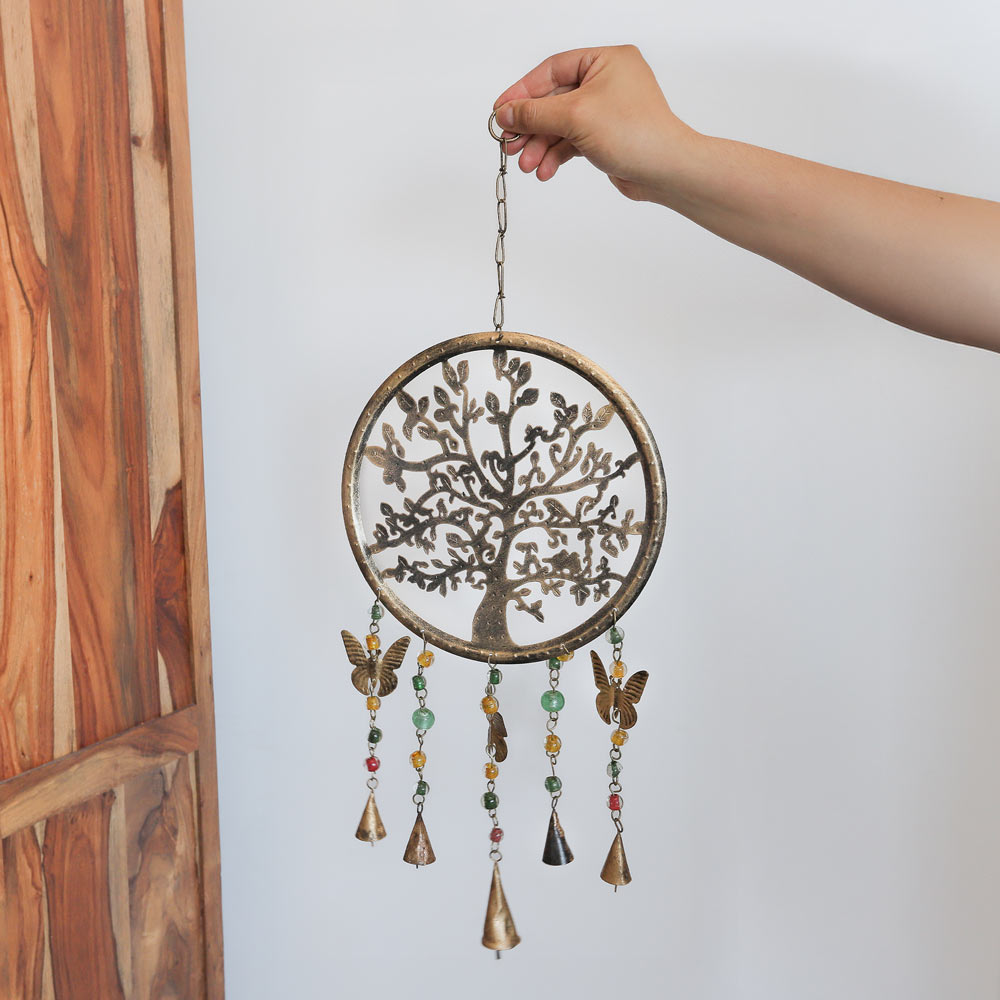 tree of life windchime next to unit in hand
