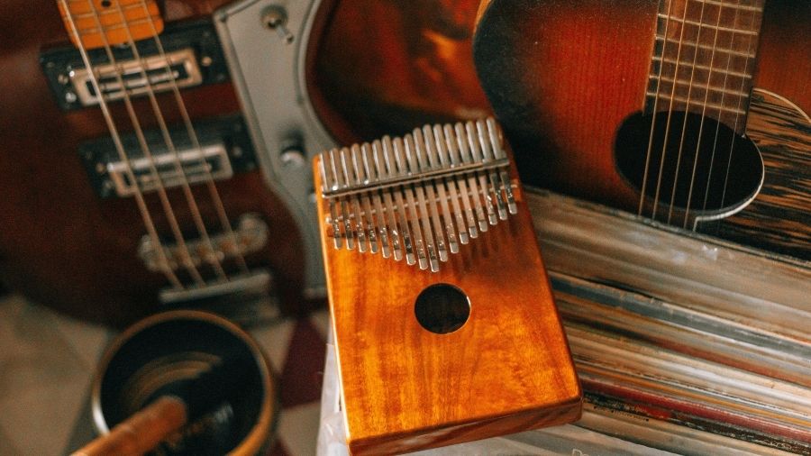 Kalimba musical instrument highlighted with guitars surrounding it.