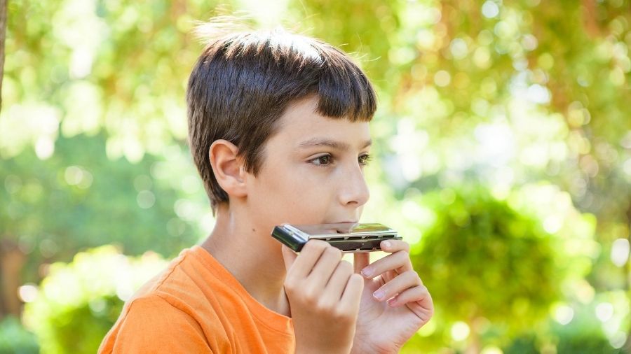 Young boy playing the harmonica