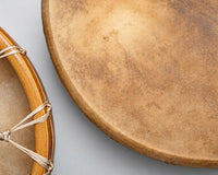 Shamanic drums of different size and a shamanic drum beater