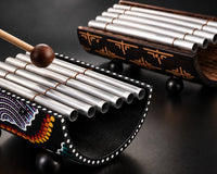 Two gamelan instruments with one being striked