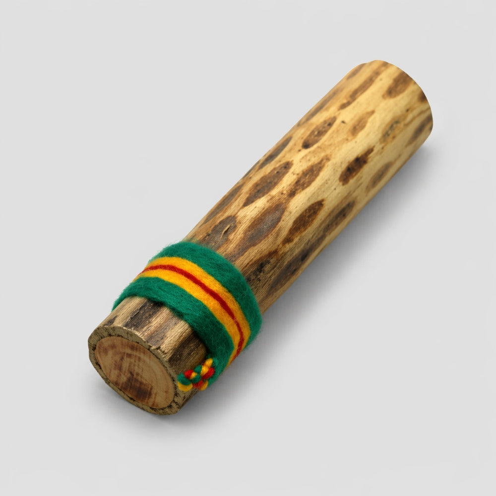 15cm cylindrical cactus rainstick shaker with green and orange woven band on a gray studio background