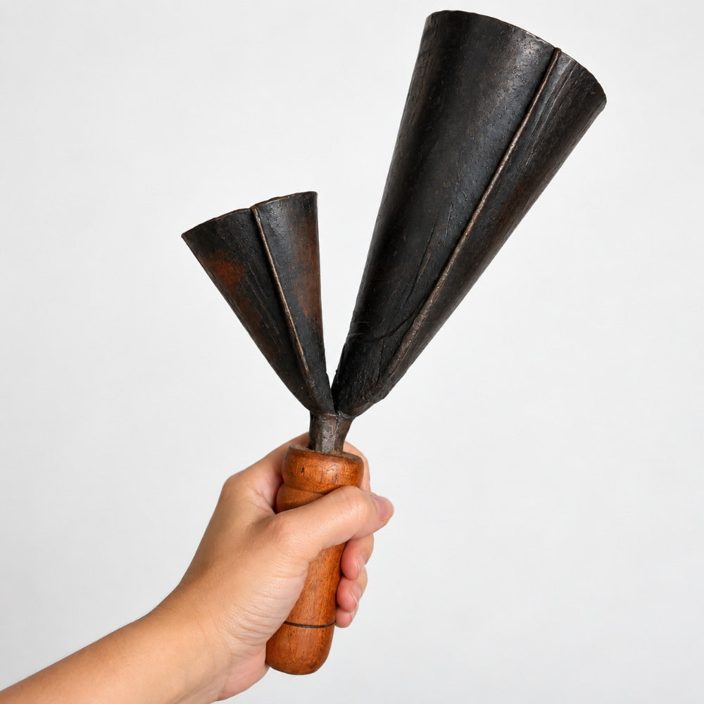 hand holding Ghanian agogo bells