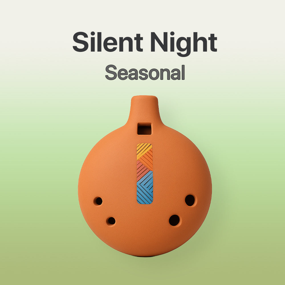 Terracotta-colored ocarina with colorful design on a light green background, labeled 'Silent Night Seasonal'.