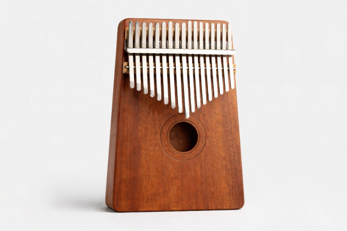 Wooden kalimba with metal tines on a white background
