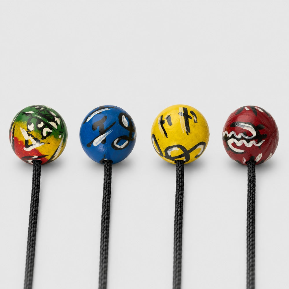 African kashaka shakers with different desgins on a light grey studio background