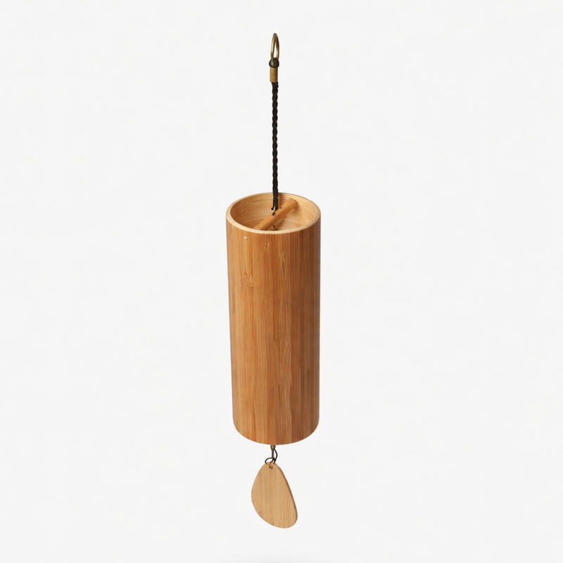 Bamboo hanging Koshi windchime with a leaf-shaped wooden pendant on a white studio background