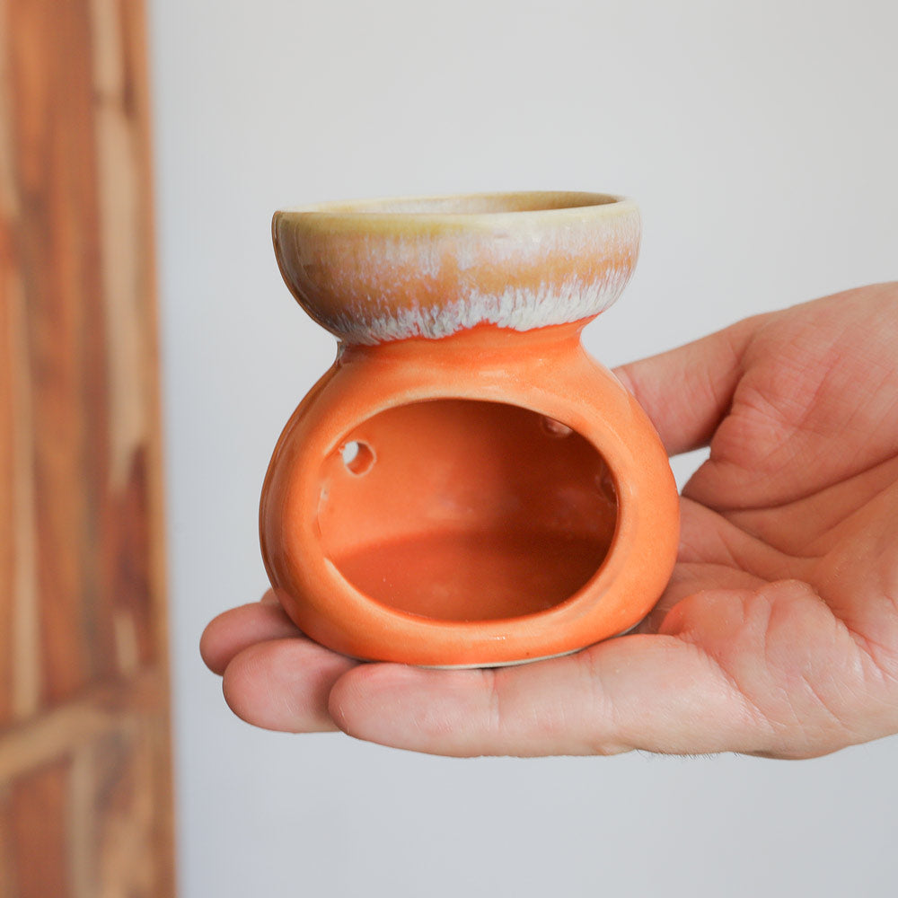 orange oil burner in hand