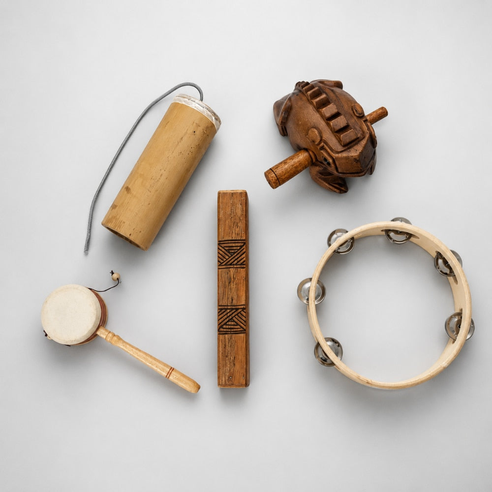 Collection of wooden percussion instruments on a light gray background