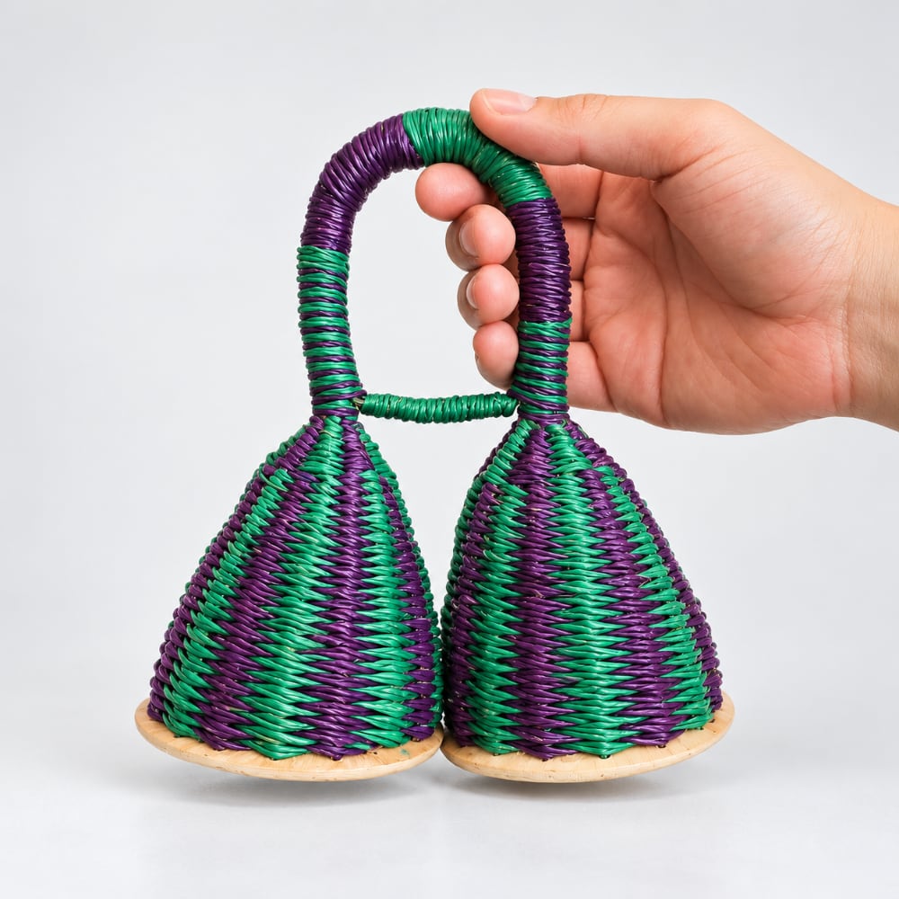 green and blue double caxixi shaker in hand to show scale size
